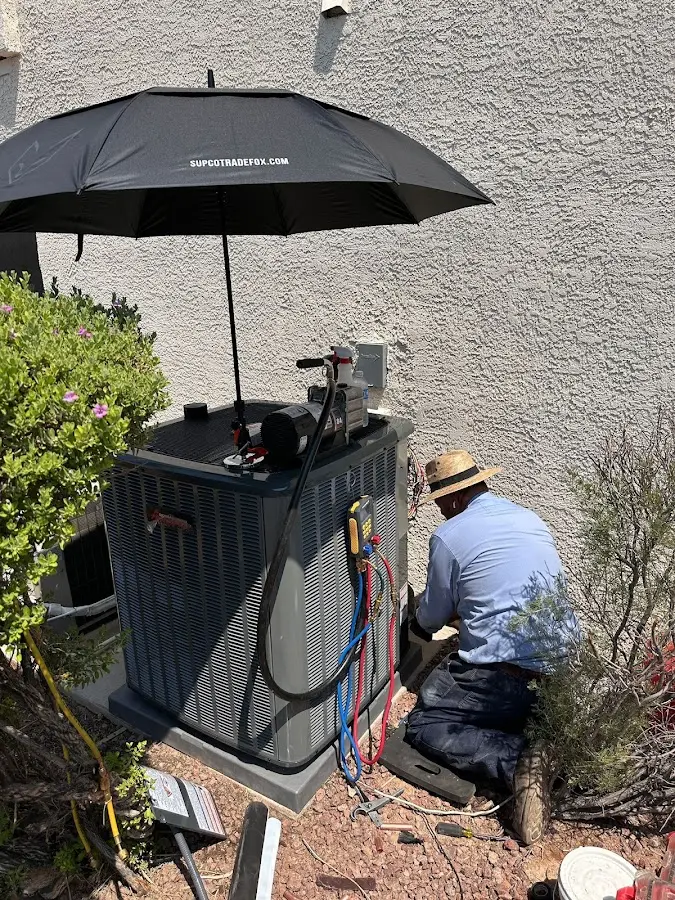 HVAC technician performing outdoor AC maintenance in Lebanon